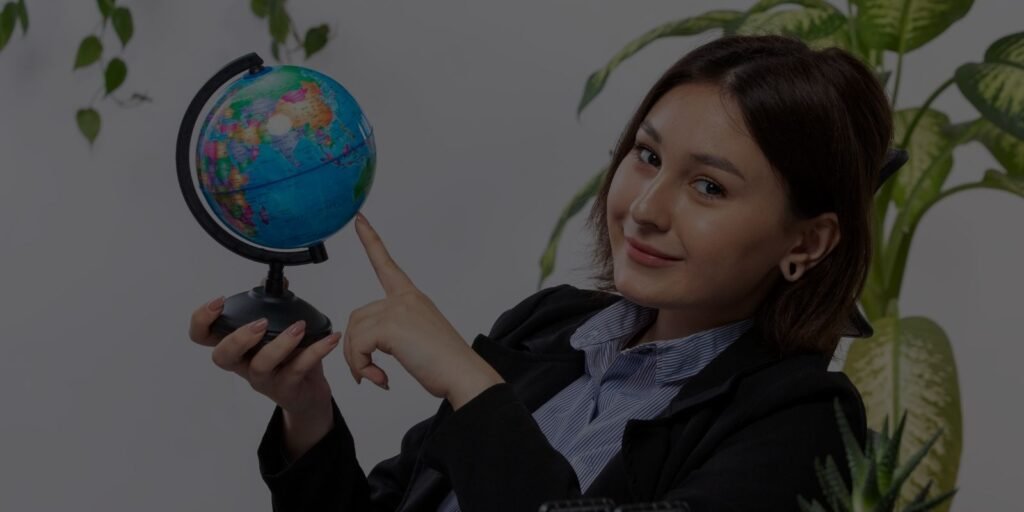 Build a Portfolio to Find International Clients - Professional Woman Holding Globe at Office Desk