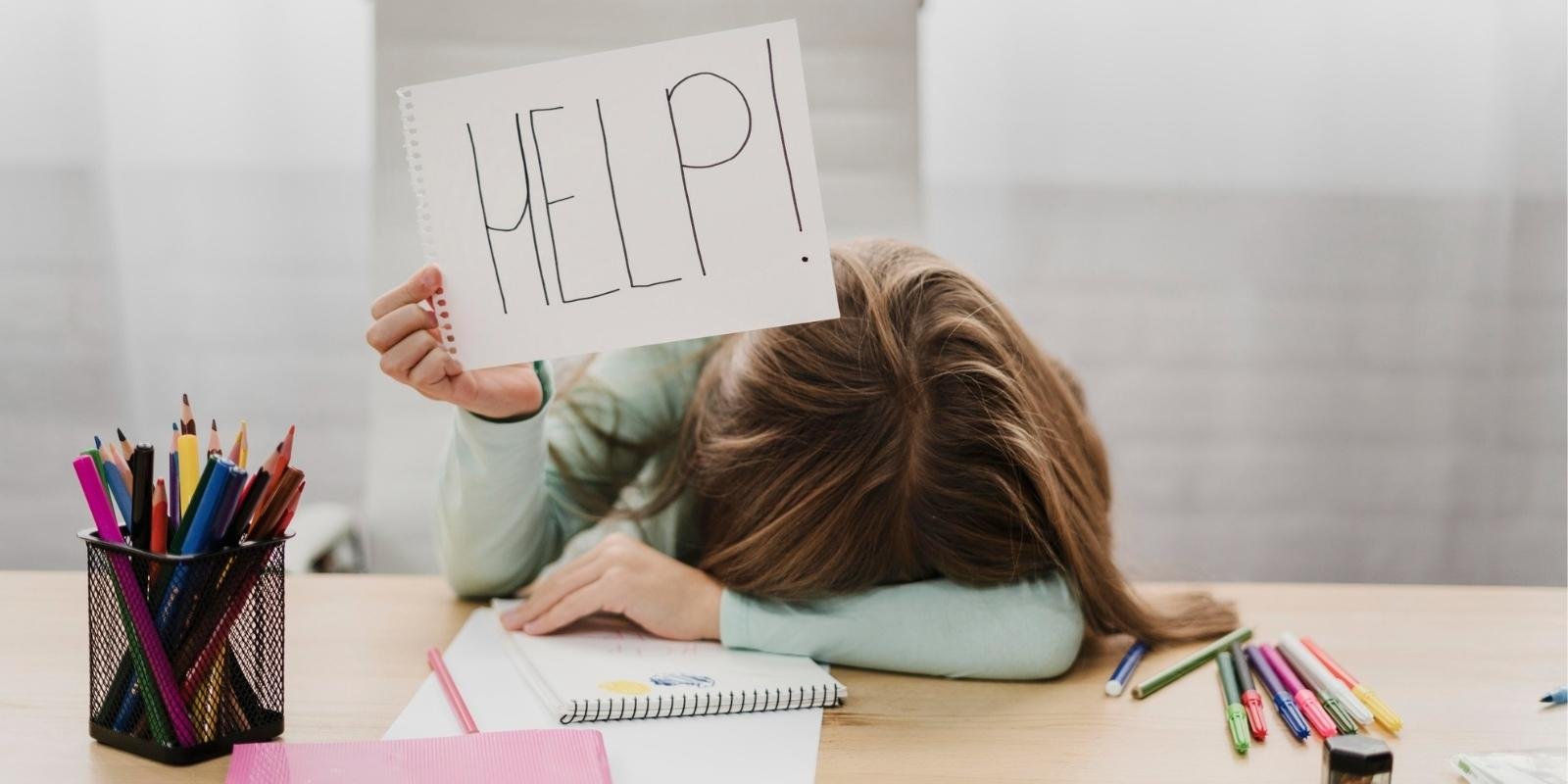 How to Stay Calm in Exam - Stressed Student Holding Help Sign at Study Desk